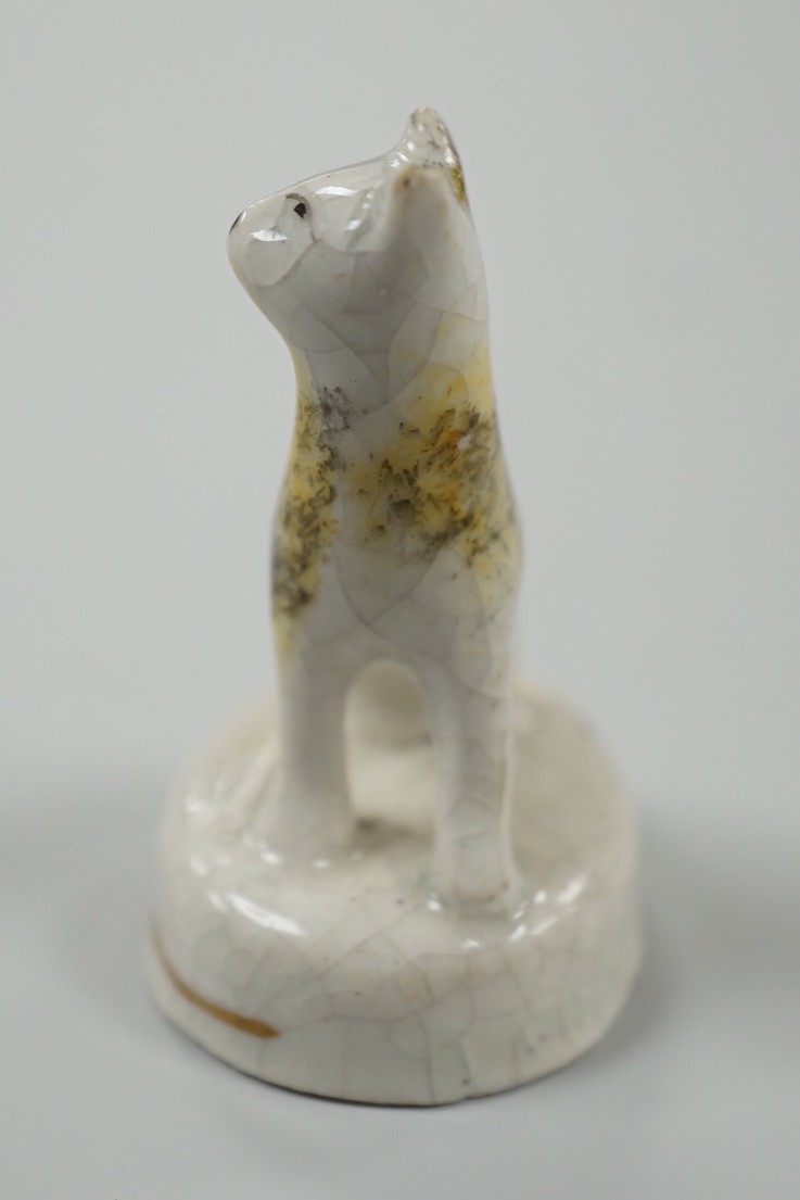 A seated toy Staffordshire model of a cat with tortoiseshell markings, c.1830-50. 4.5cm tall, Provenance: Dennis G.Rice collection